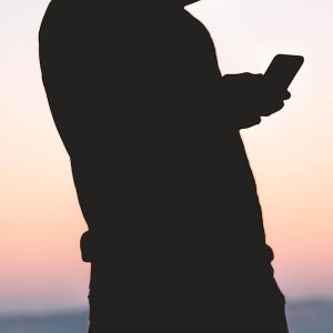 silhoutte of person using smartphone